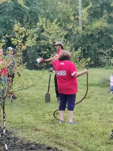 person handing out water to workers outside