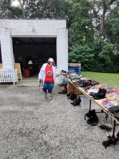 person in white coat and hat placing shoes on a table