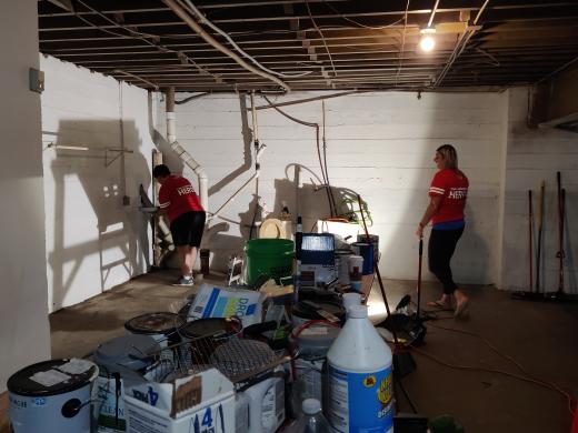 two people painting basement walls