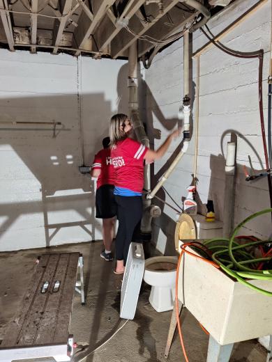 two people painting basement walls