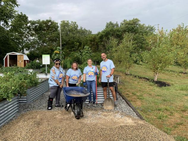 Group of People with a Wheelbarrow and shovels 